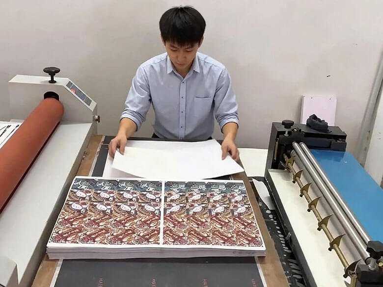 Workers Coating Scented Cards With Glue Coating Machine - FEILIZTECH Fragrance Production