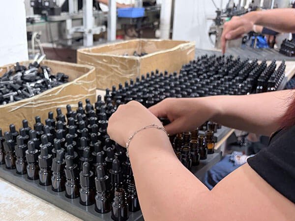 Essential Oil Bottles Displayed On Household Scent Machine Assembly Line Desk